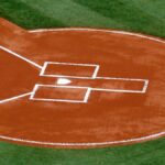 A top-down view of a baseball field's home plate area on a sunny day.