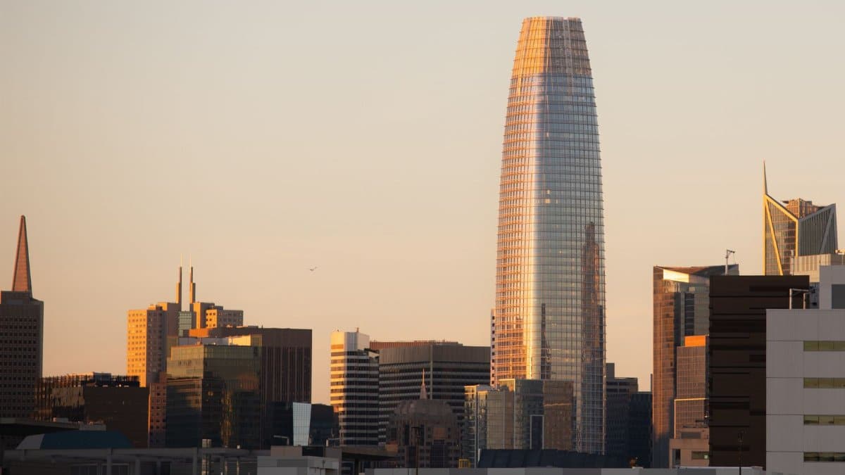 San Francisco skyline featuring modern skyscrapers at sunset, highlighting Salesforce Tower.