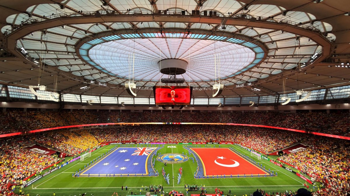 Vibrant soccer match at BC Place, Vancouver, showcasing international team flags.