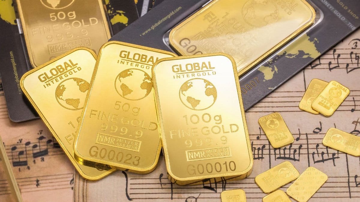 Gold bars stacked on sheet music, showcasing wealth and luxury with fine detail.