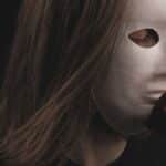 Mysterious portrait of a person with a white mask holding a red rose. Dark and intriguing mood.