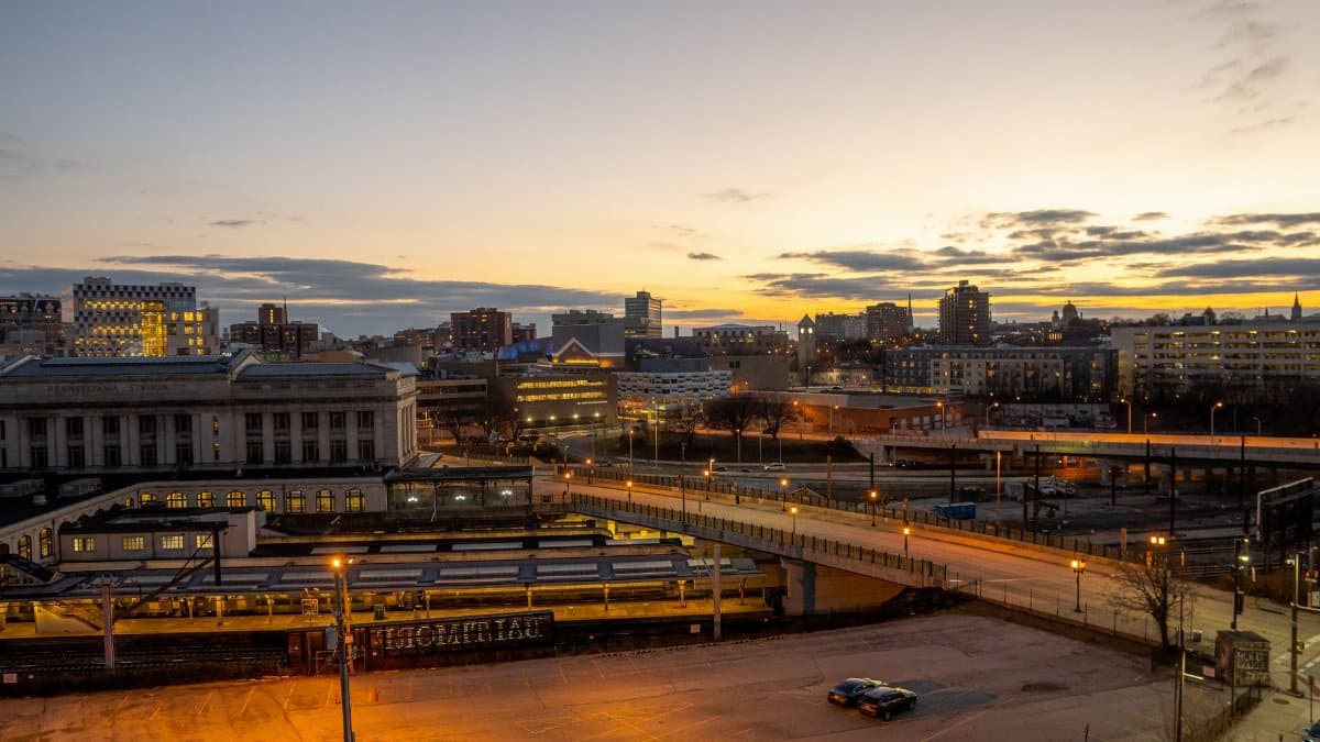 Aerial view of Baltimore cityscape at dusk, showcasing urban architecture and illuminated streets.