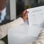 African American man wearing face mask casting a vote with official ballot
