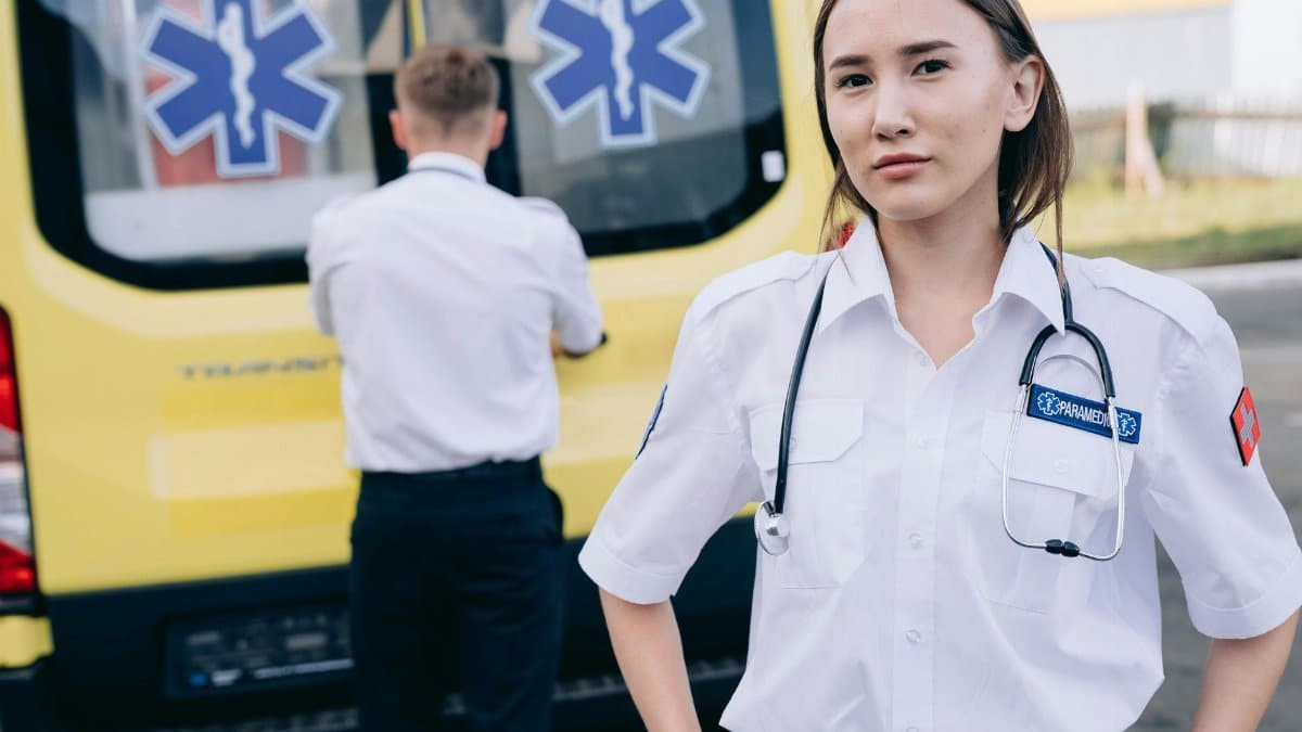 Paramedic team ready for emergency response beside ambulance.