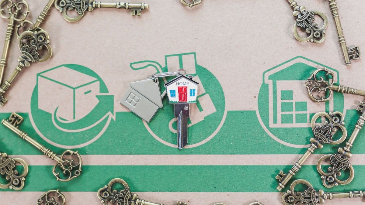 A collection of vintage keys with a modern house key symbolizing real estate investment.