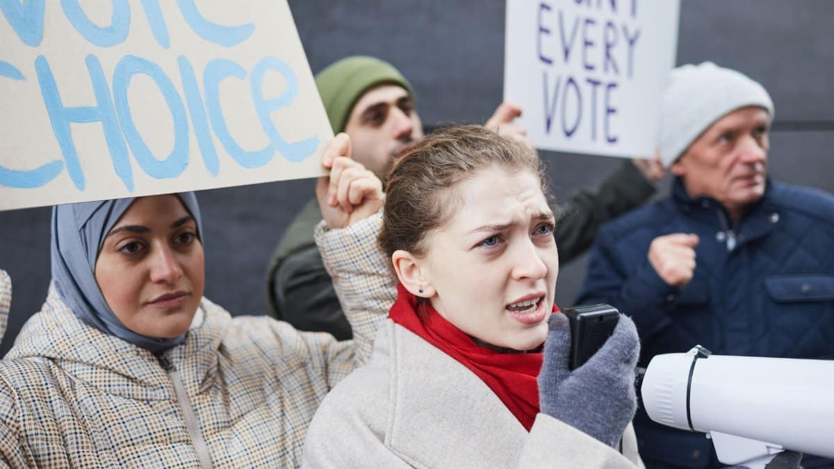 People protesting with signs demanding fair voting practices and choice.