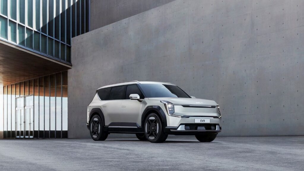 Kia EV9 electric SUV parked in an urban architectural environment, showcasing modern design.