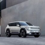 Kia EV9 electric SUV parked in an urban architectural environment, showcasing modern design.