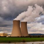 Scenic view of a nuclear power plant with cooling towers emitting steam in Hameln, Germany.