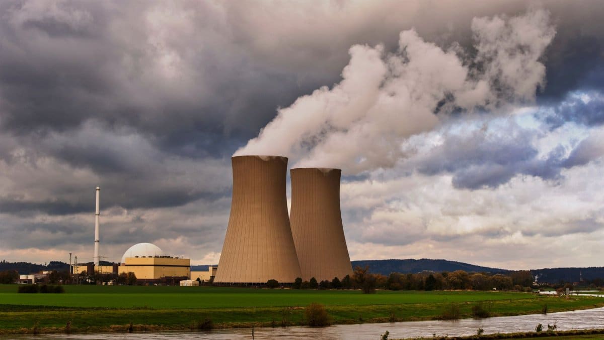 Scenic view of a nuclear power plant with cooling towers emitting steam in Hameln, Germany.