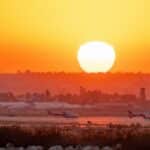 Stunning sunset at San Bernardino Airport with planes and vibrant sky.