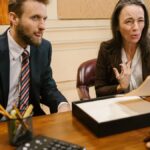 Lawyers discussing legal documents in a professional office setting.