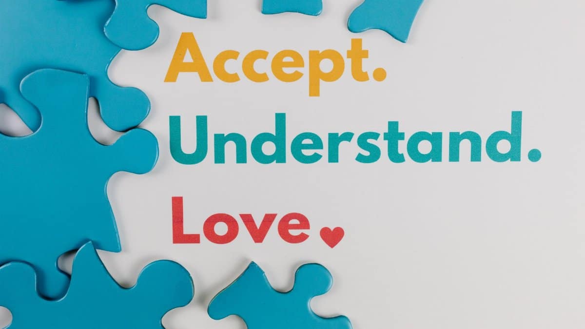Colorful puzzle pieces with words 'Accept. Understand. Love.' symbolize autism awareness.