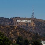 View of the iconic Hollywood Sign on Mount Lee with clear blue skies in Los Angeles, California.