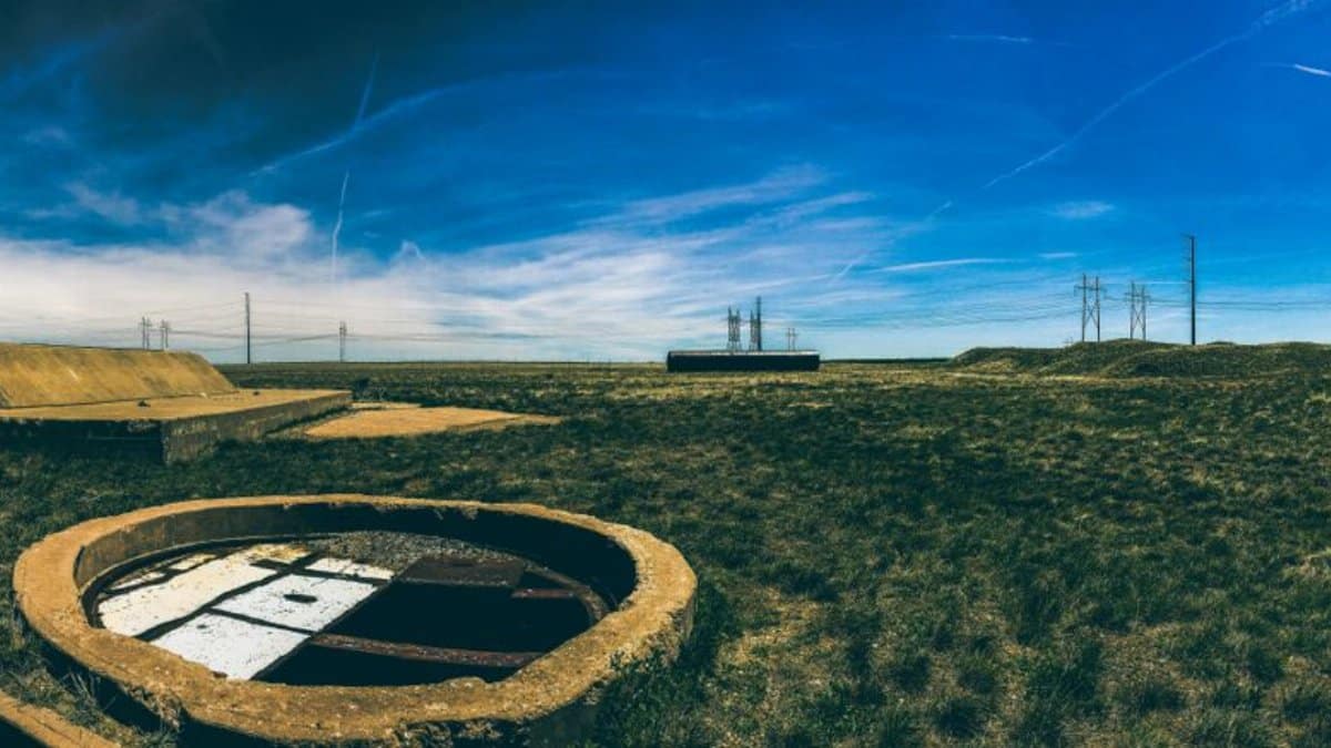 Panoramic view of an abandoned missile silo under a clear blue sky in Deer Trail, Colorado.