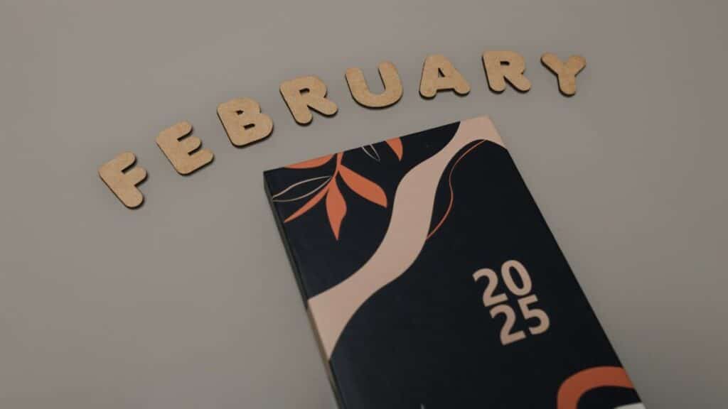 Artistic 2025 planner on a minimalist background with the word "February" in decorative letters.