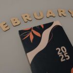 Artistic 2025 planner on a minimalist background with the word "February" in decorative letters.