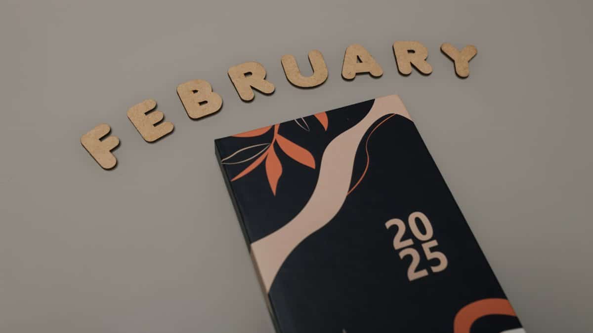 Artistic 2025 planner on a minimalist background with the word "February" in decorative letters.