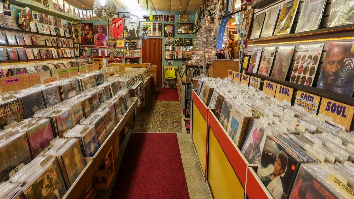 Cozy and colorful vinyl record store with rows of classic records and vibrant decor.