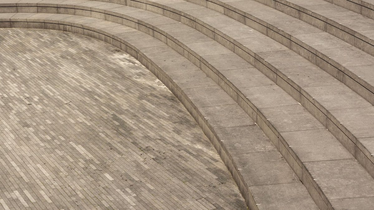 Curved stone amphitheater steps with textured tiles. Ideal for architectural concepts.