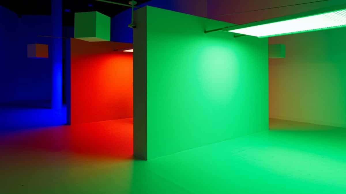 Vibrant room with blue, red, and green lighting creating a modern artistic ambiance.