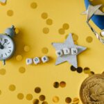Conceptual flat lay of a trophy, medal, and clock with 'FOR WIN' letters, symbolizing victory and achievement.