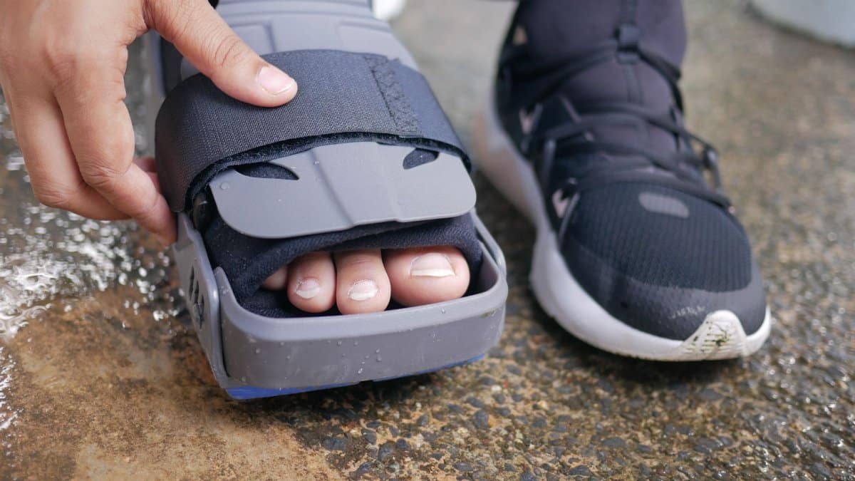 Detailed close-up of a foot in an orthopedic brace, highlighting post-injury recovery.
