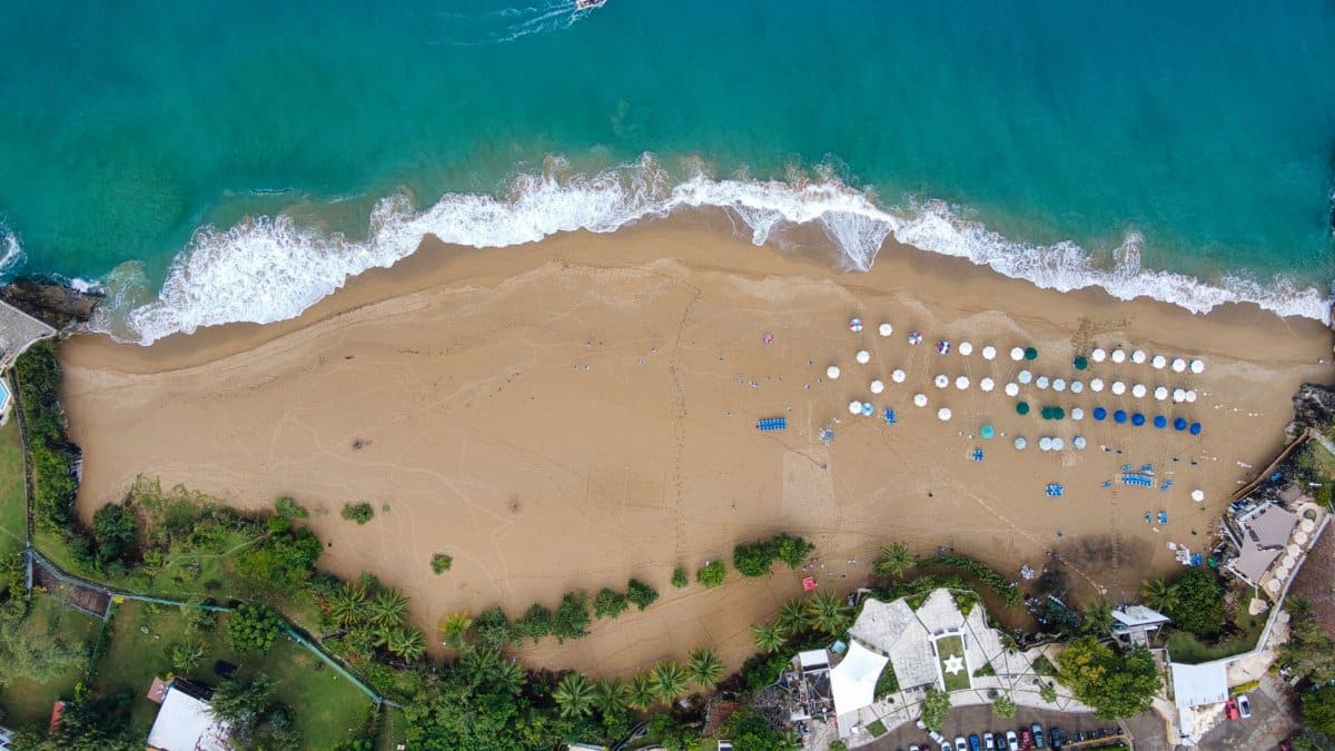 Stunning aerial shot of Sosúa Beach, Puerto Plata, showcasing crystal waters and sandy shores.