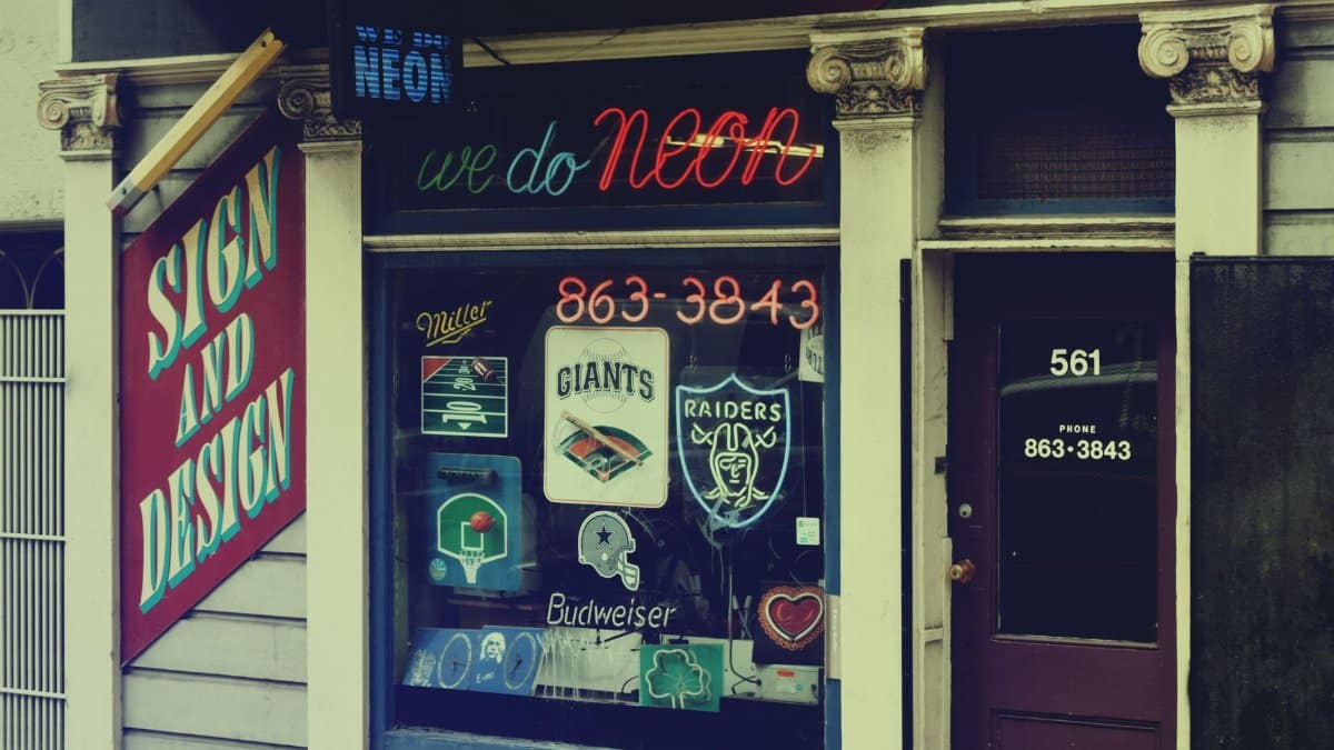 A vibrant neon sign shop front with classic designs in San Francisco's Mission District.