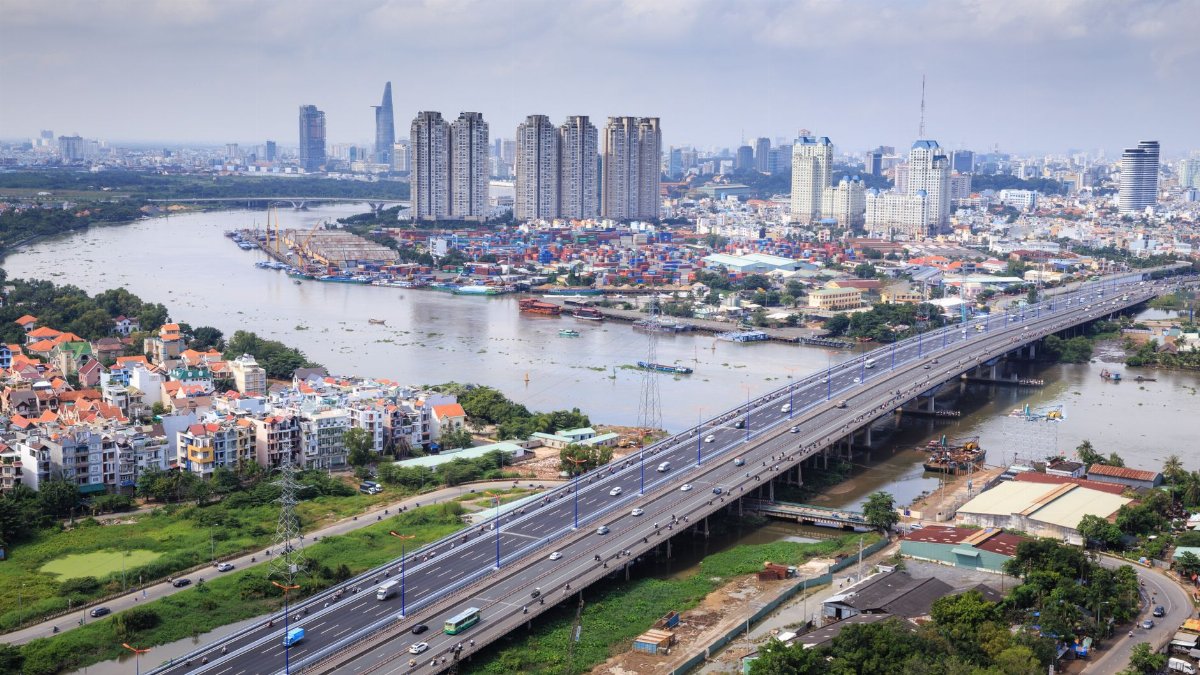 An aerial shot showcasing the skyline and river of Ho Chi Minh City, highlighting its urban landscape.