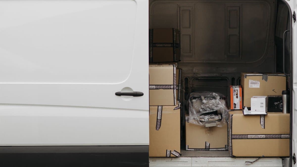 Open delivery van filled with boxes, ready for logistics and transport services.