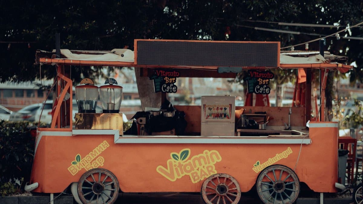 An inviting orange juice bar cart, perfect for urban street vibes.