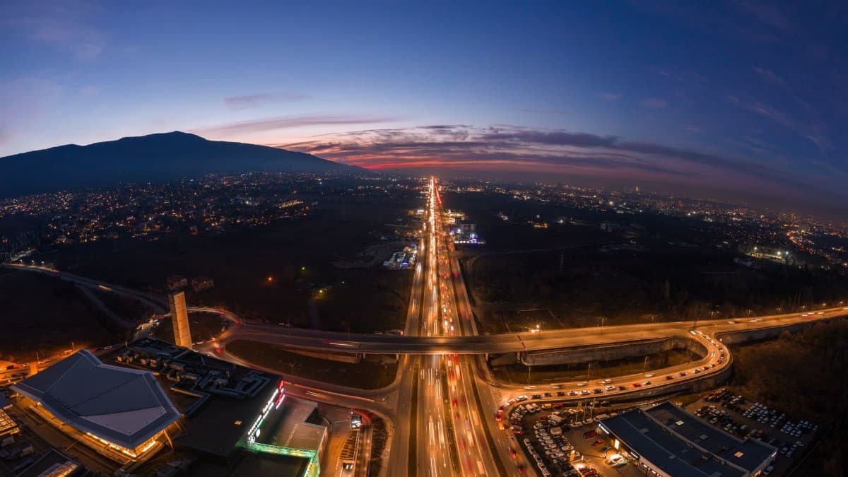 A breathtaking aerial cityscape of Sofia, Bulgaria, showcasing its vibrant streets at twilight.