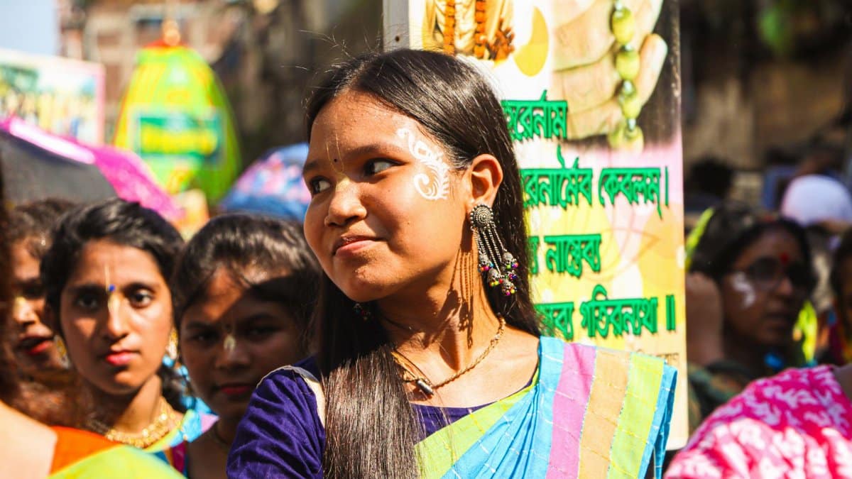 Young women in vibrant traditional attire enjoying a festive celebration in Dhaka, Bangladesh.