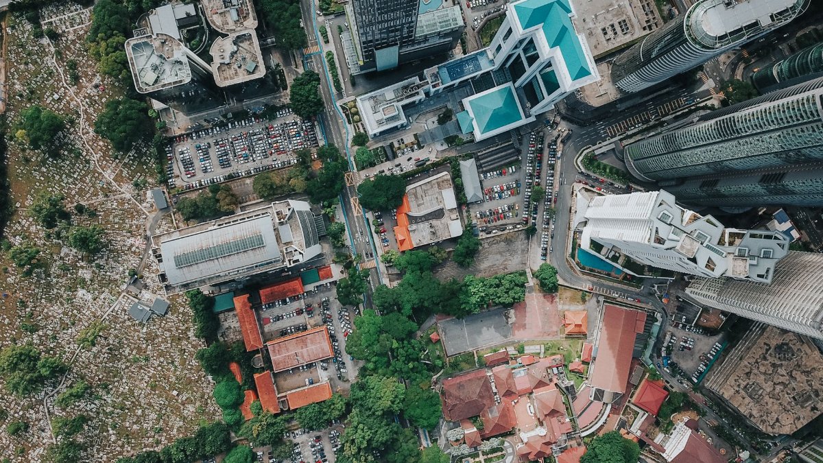 Drone view of big city district with glass skyscrapers and urban contemporary buildings