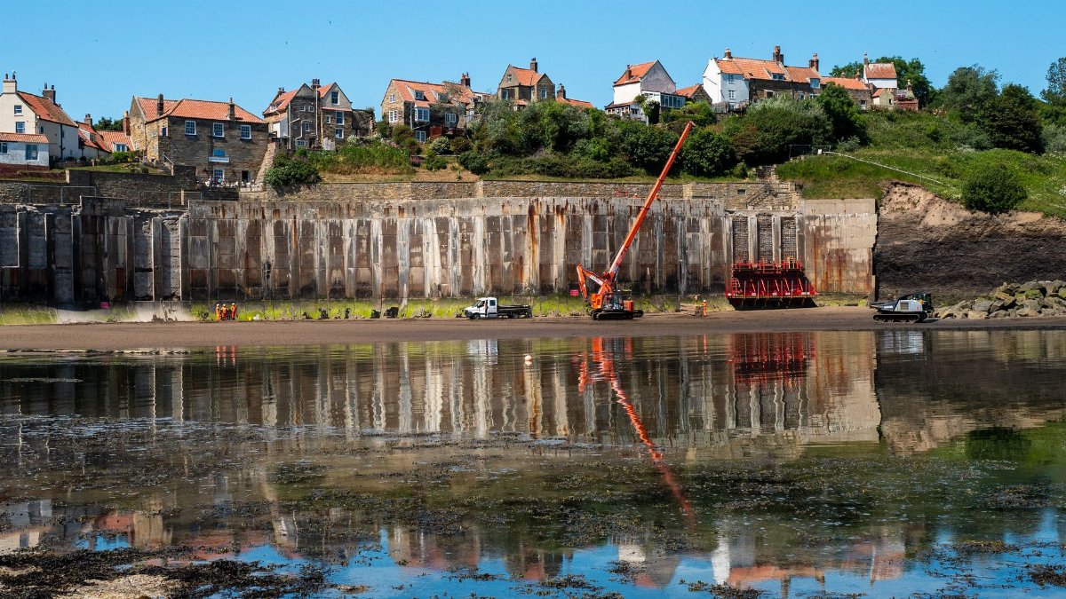 Crane and sea wall construction at Robin Hood's Bay, England.