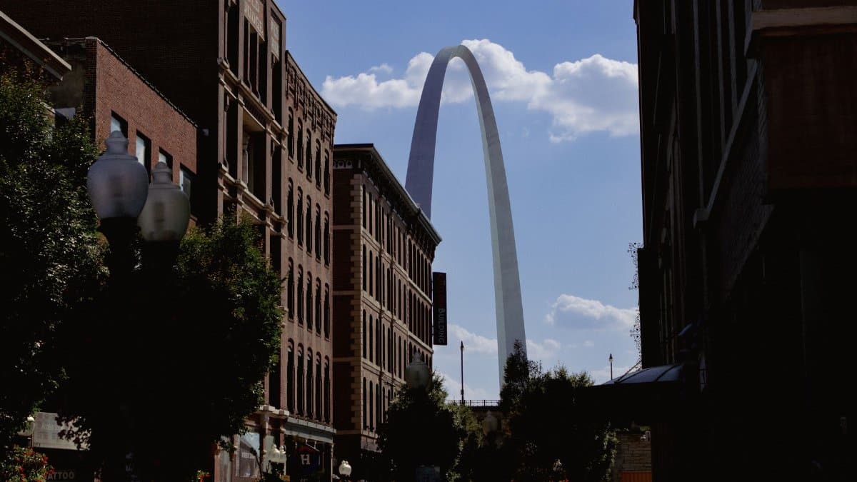 The iconic Gateway Arch rises between city buildings in St. Louis, USA.