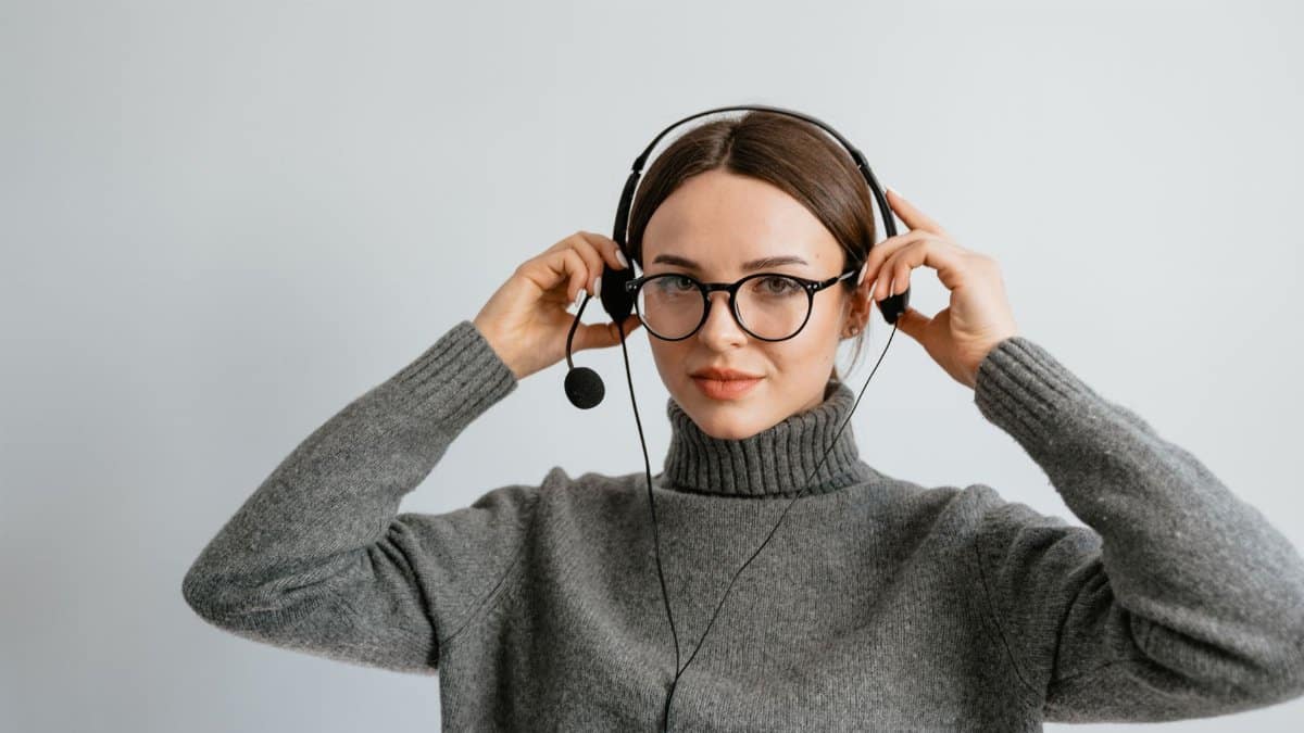 Confident woman with a headset providing professional customer support indoors.
