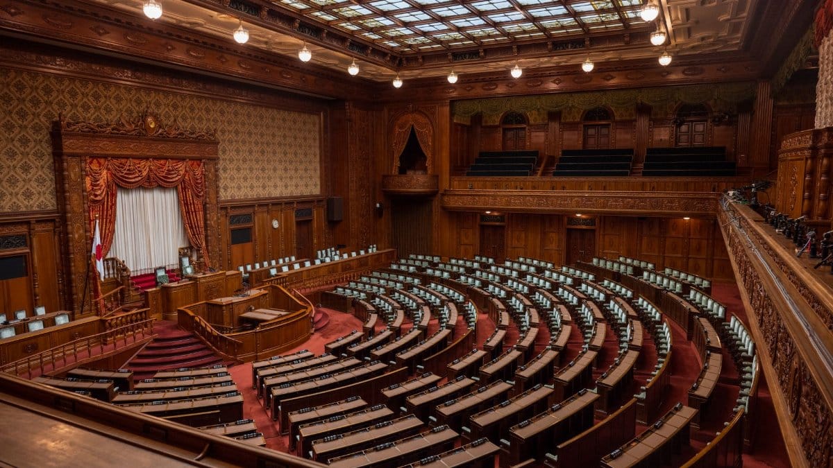 Captivating wide-angle view of a classic legislative assembly hall with ornate wood design.