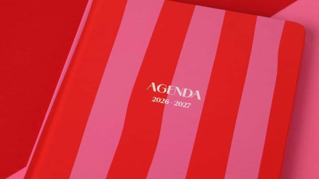 Red and pink striped agenda book for 2026-2027, perfect for planning.
