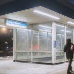 Person entering Logan Square CTA Blue Line station at night in winter.