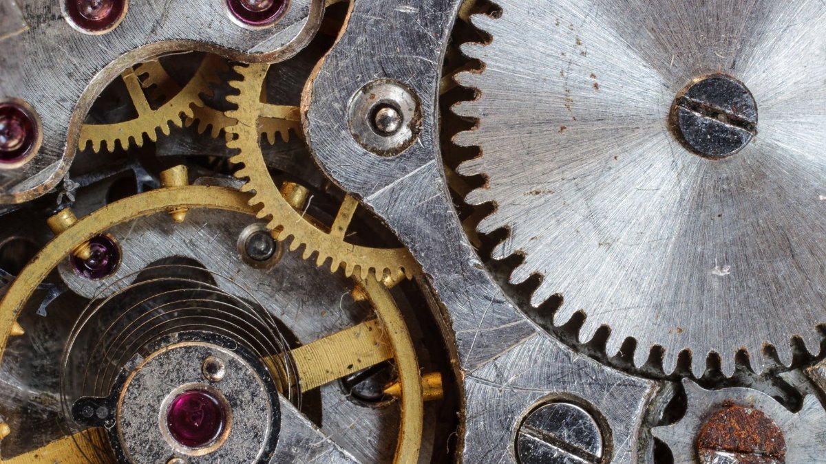 Detailed close-up of interlocking gears and cogs in a complex mechanical system.