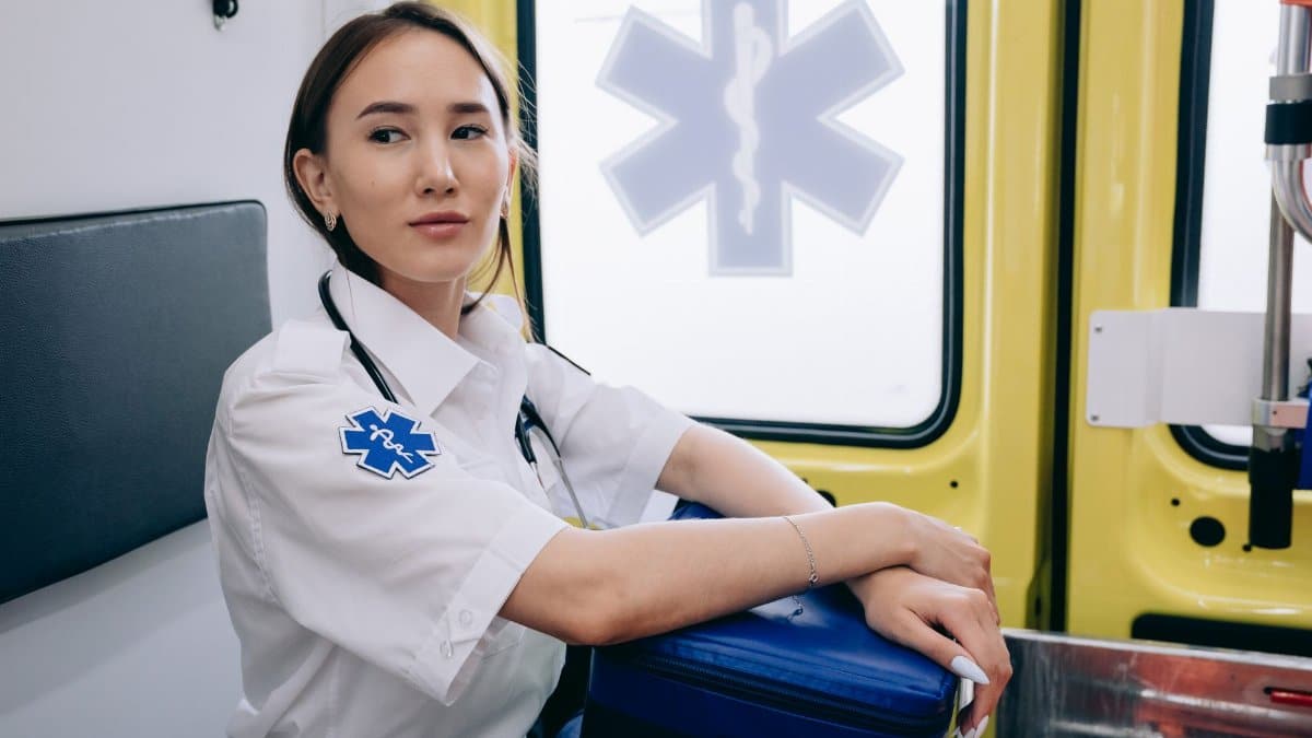 Asian woman paramedic inside an ambulance ready for emergency response.