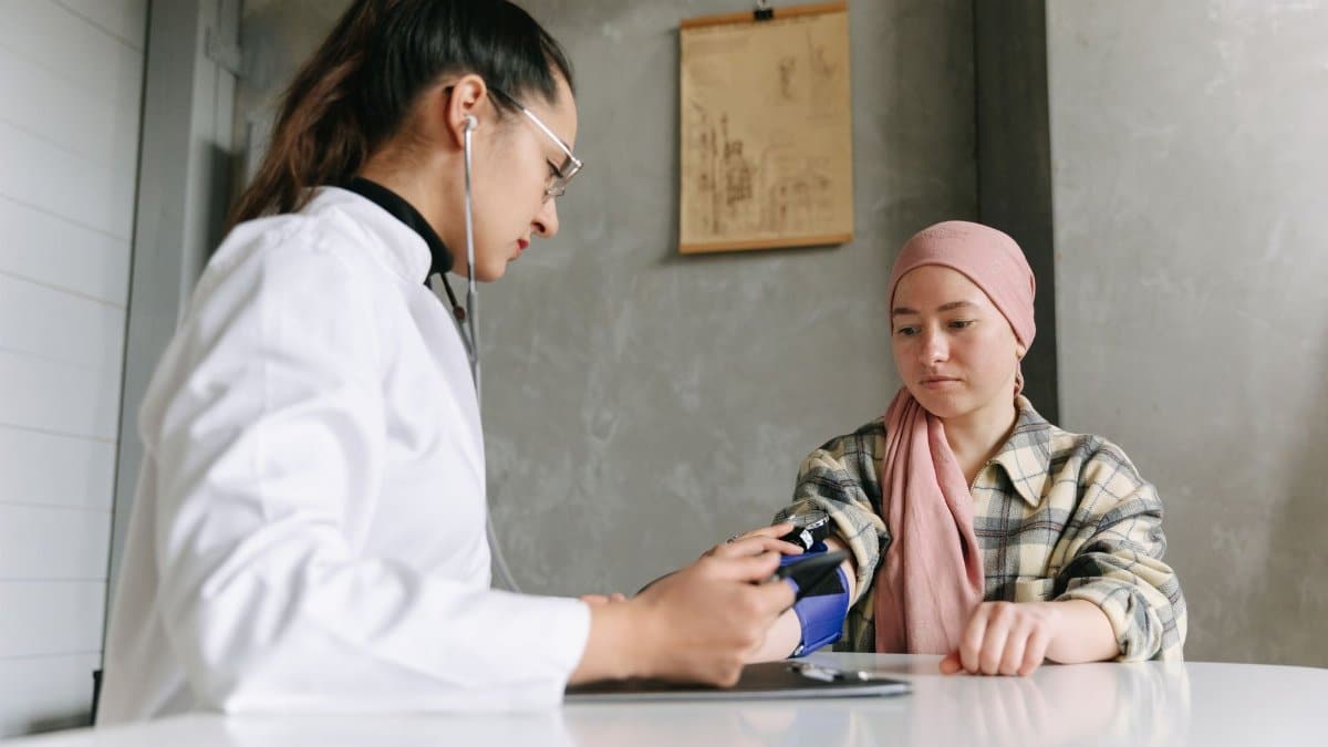 A medical professional checks a patient's blood pressure, depicting a caring healthcare environment.