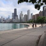 Scenic view of Chicago skyline from Lake Michigan trail with runners and cityscape view.
