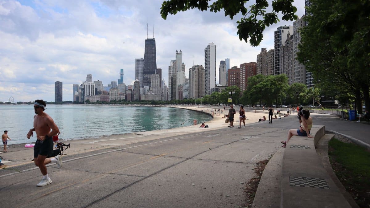 Scenic view of Chicago skyline from Lake Michigan trail with runners and cityscape view.