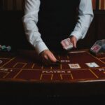 A casino dealer handling cards at a gaming table, ready for blackjack or poker.