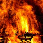 Intense flames engulf wooden pallets in a breathtaking display of fire and heat.