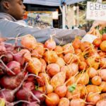 A vivid scene at a farmers market with fresh beets for sale, highlighting local produce and community commerce.
