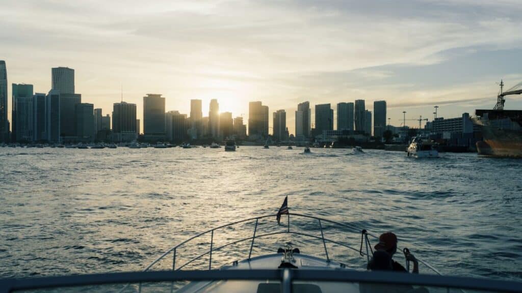 Enjoy a serene boat ride with Miami's iconic skyline at sunset, offering a perfect urban escape.